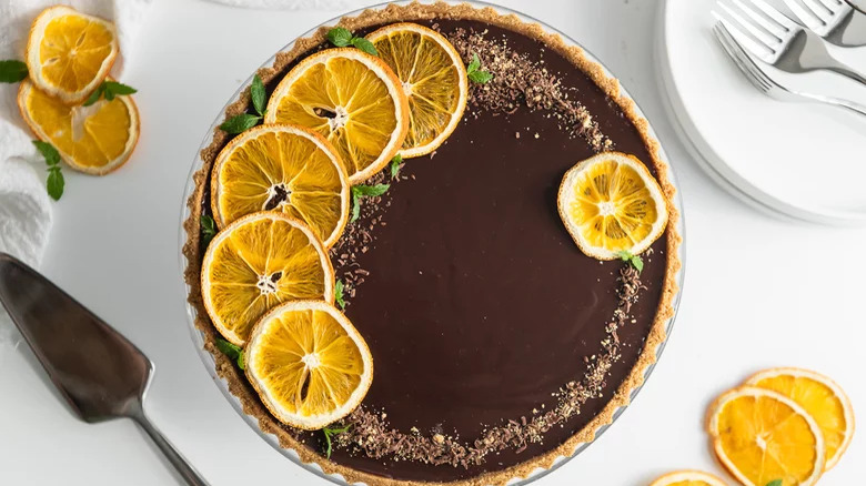 A chocolate tart with orange slices