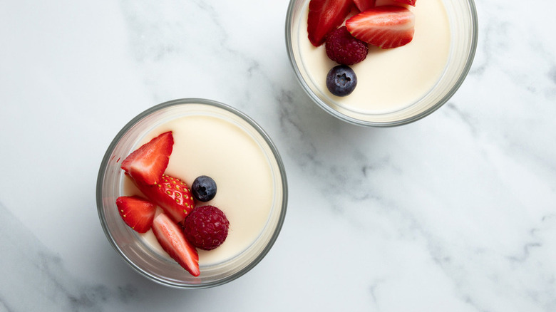 Two bowls of panna cotta with berries on top