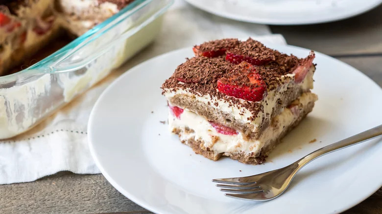 A slice of tiramisu with strawberries