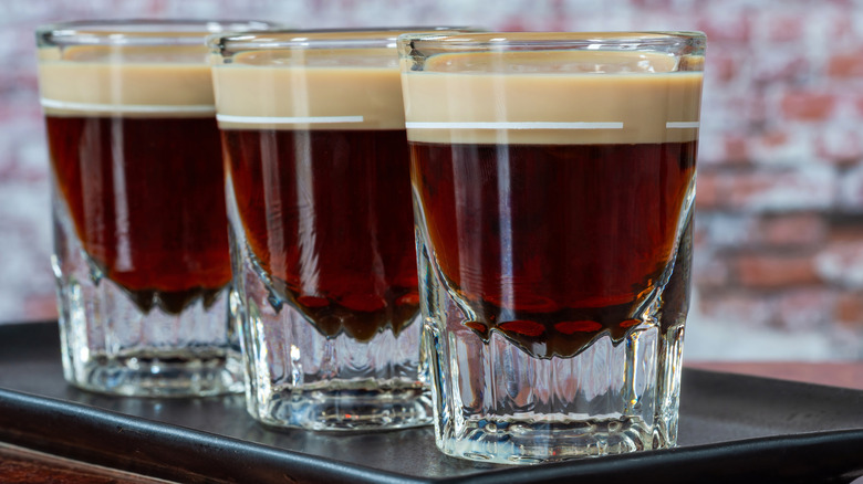 Row of three baby Guinness layered shots