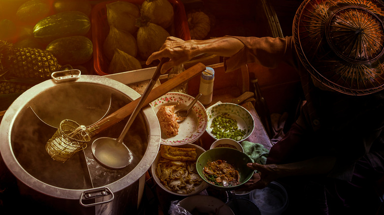 Thai man making noodle soup