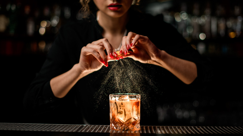 bartender makes an old fashioned