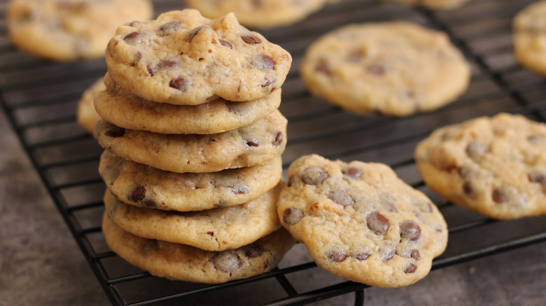 Chocolate chip cookies stacked on cooling rack