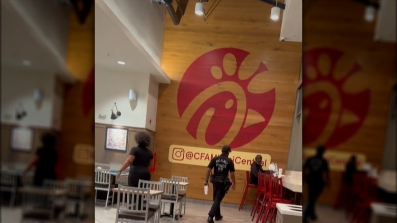 chick-fil-a security guard approaching homeless man