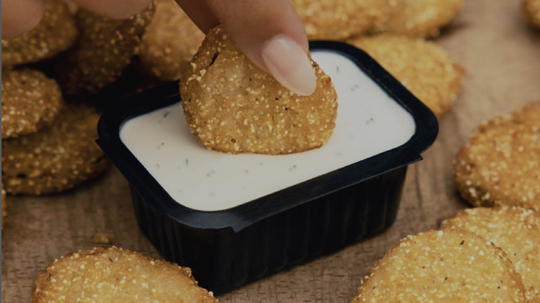 Hand dipping Zaxby's fried pickles