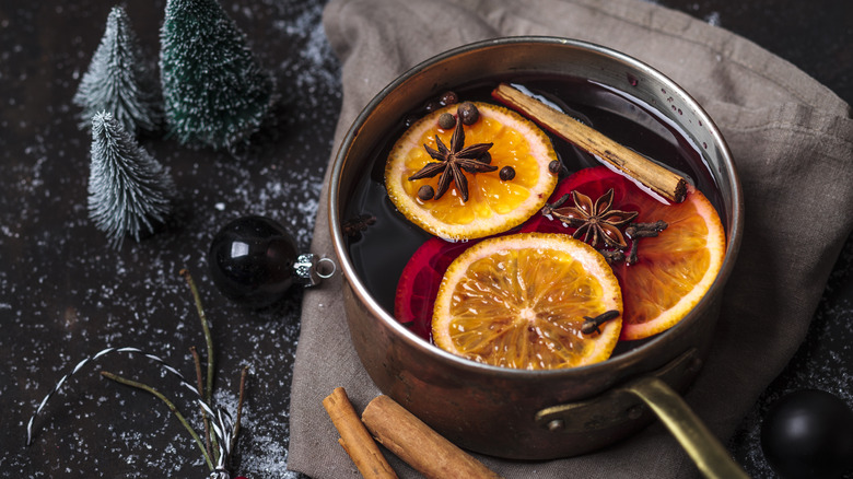 pot of mulled wine with oranges and spices