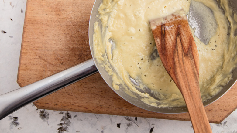 roux being stirred with a wooden spatula