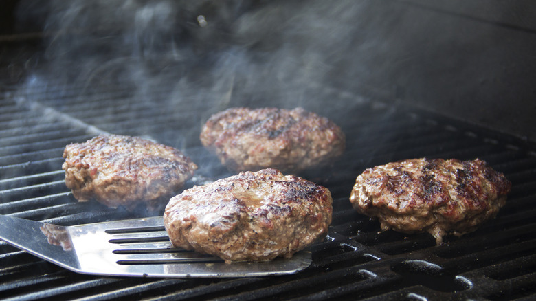 burgers being cooked on a grill