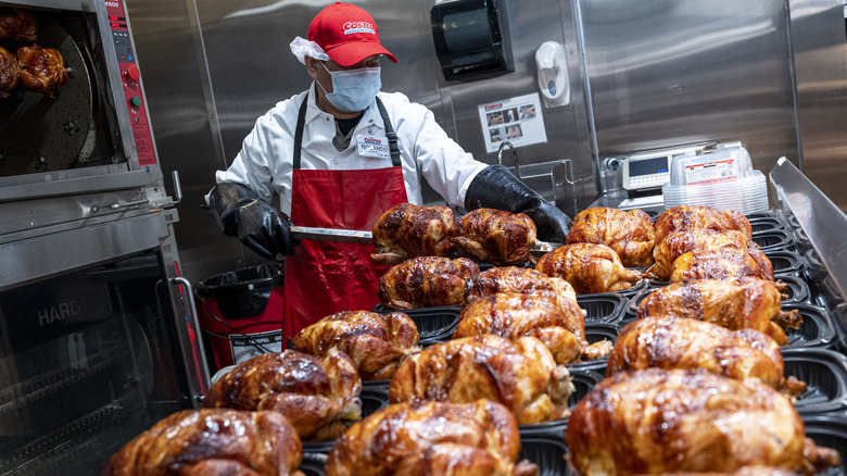 costco worker and rotisserie chicken