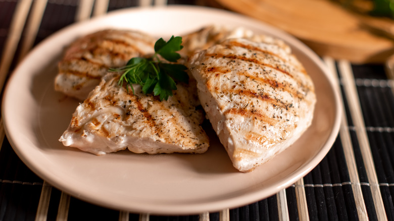 Grilled chicken breasts on plate