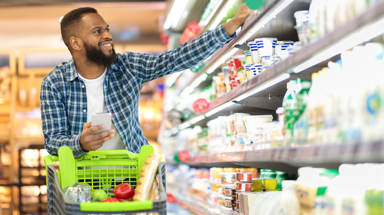 Man picking out groceries in supermarket 