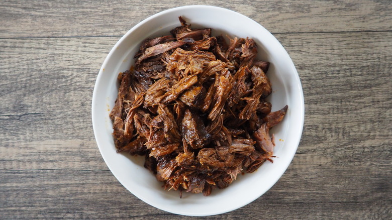 shredded beef in white bowl