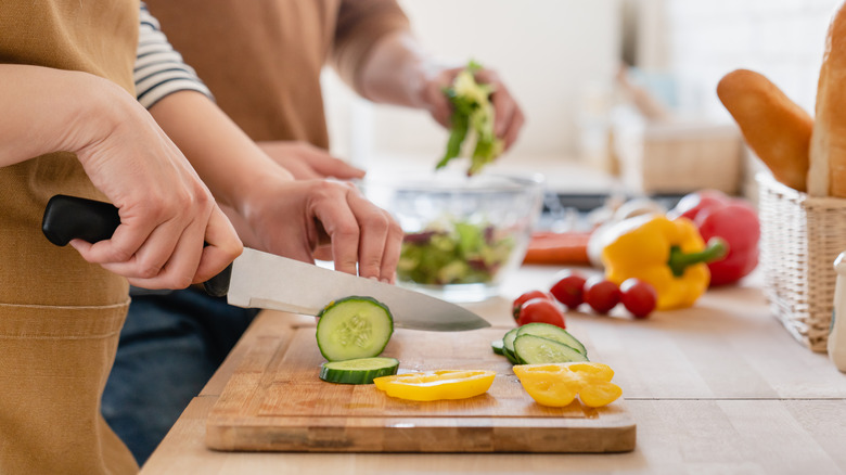 Chopping vegetables on brown board