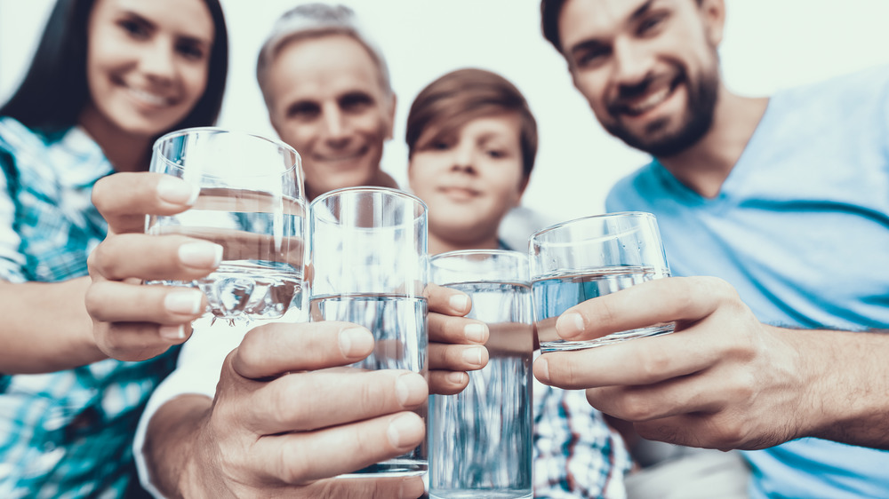 People drinking water out of glasses