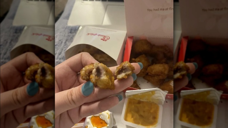 Person holding discolored Chick-fil-A chicken nugget