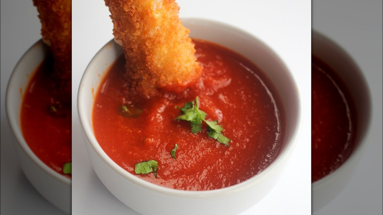 Mozzarella stick dipped in marinara