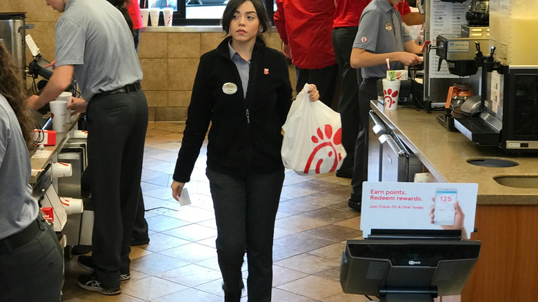 Chick-fil-A employee carrying customers' food