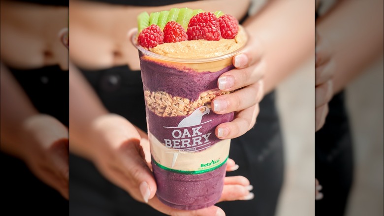 person holding oakberry acai