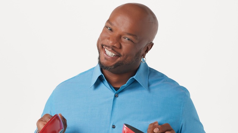 Chef Aaron McCargo Jr. holds Cook's Essentials pans