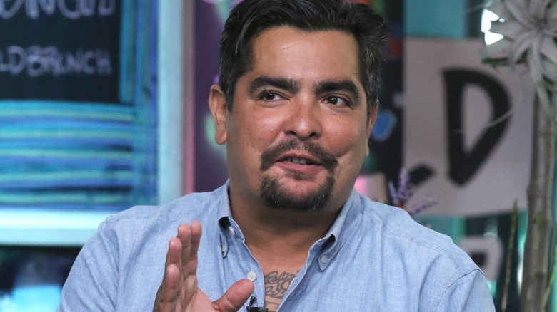 Chef Aaron Sanchez in blue shirt