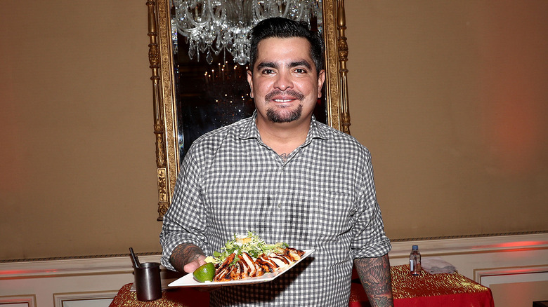 Aaron Sanchez holding plate of food