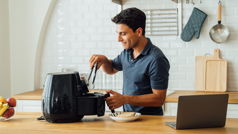 Person using air fryer