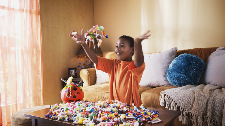 Kid throwing Halloween candy