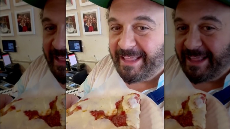 Adam Richman holding focaccia pizza