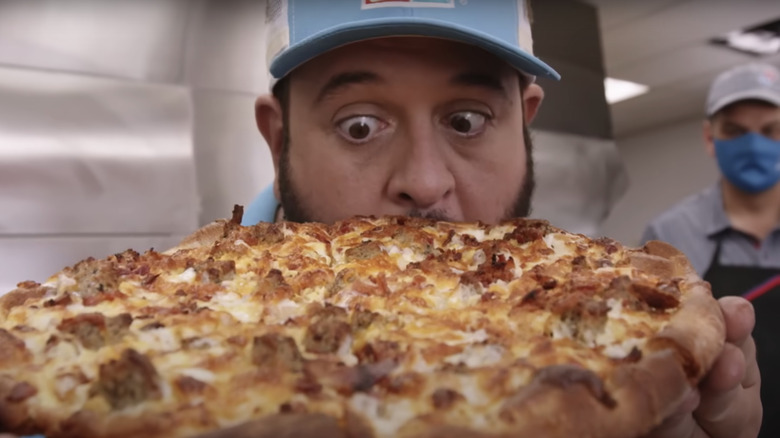 Adam Richman with Domino's breakfast pizza