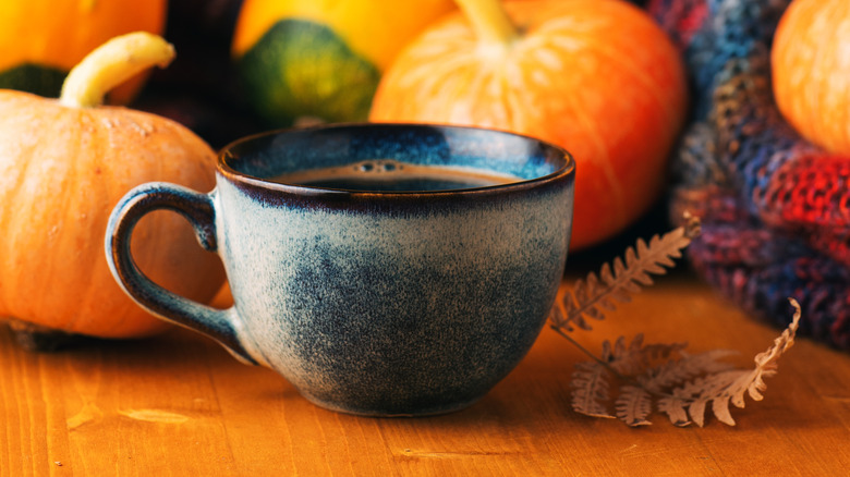 Cup of espresso with pumpkins