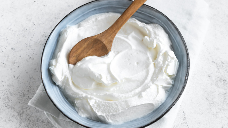 bowl of Greek yogurt with wooden spoon