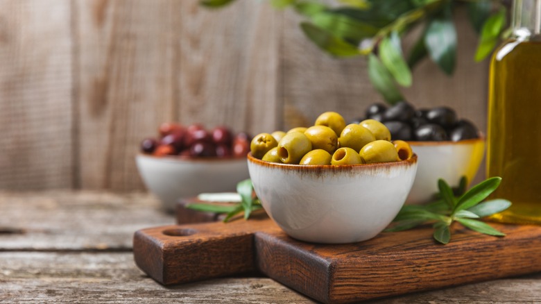 three types of olives in bowls