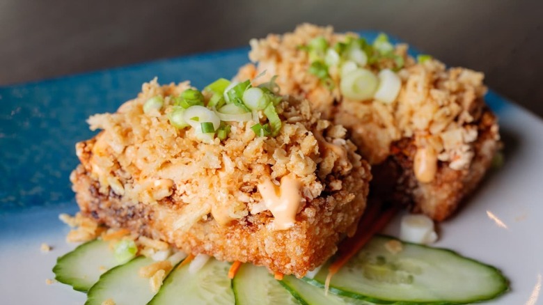 crispy rice topped with fish and garnishes