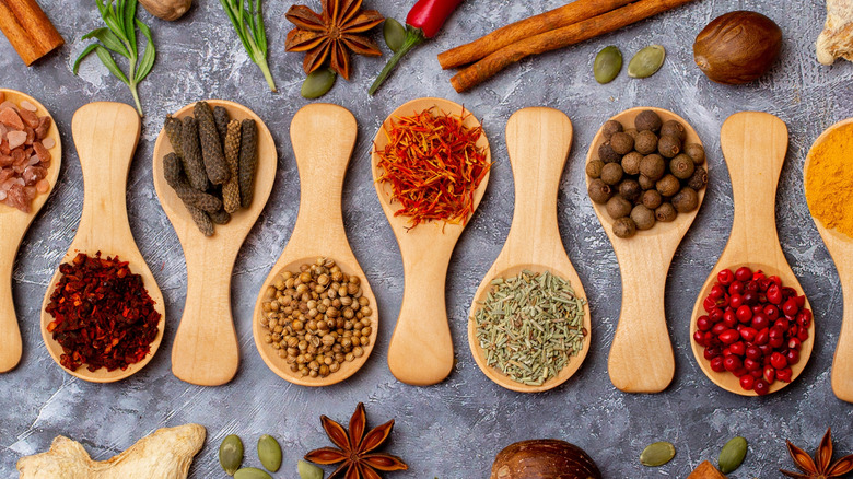 Assorted spices and seasonings in large wooden spoons