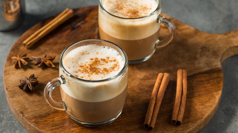 two espresso lattes in glass mugs with connamon and star anise