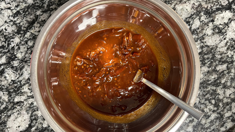 Mashing chipotles in adobo with fork in bowl