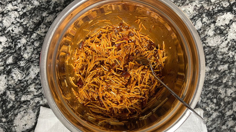 Chipotle peppers mixed with shredded cheddar cheese in bowl