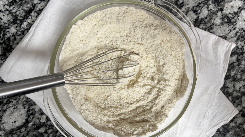 Whisking dry masa ingredients in glass bowl