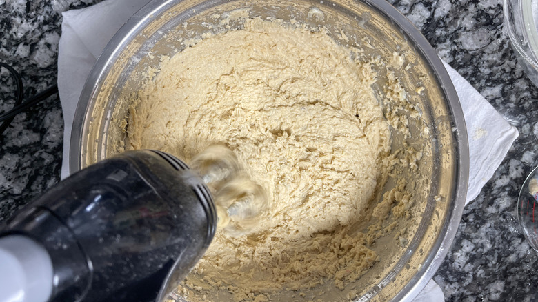 Whipping masa ingredients in metal bowl