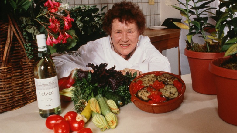 Julia Child posing with vegetables