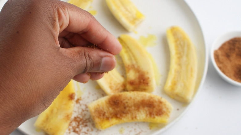 sprinkling sugar on bananas