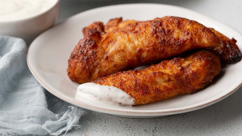 chicken tenders on plate with ranch sauce