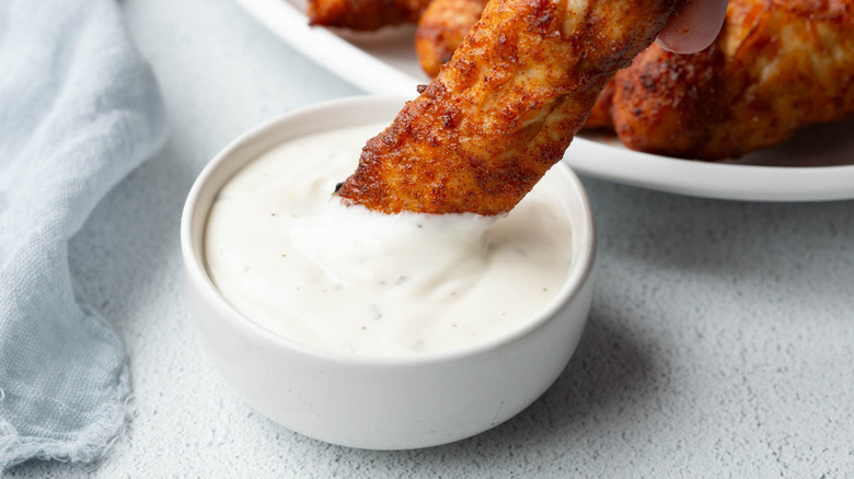 chicken tender dipping into ranch