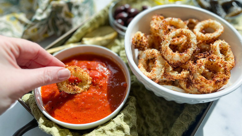 calamari dunking in marinara sauce