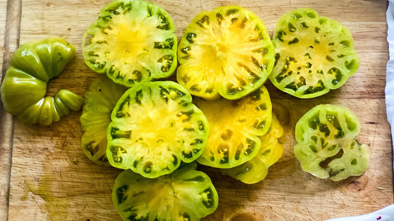 sliced green tomatoes on cutting board