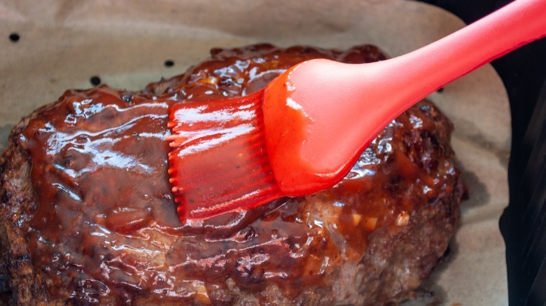 brushing glaze onto meatloaf