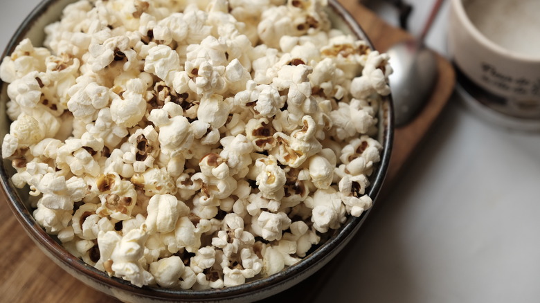 Bowl of popcorn on plank