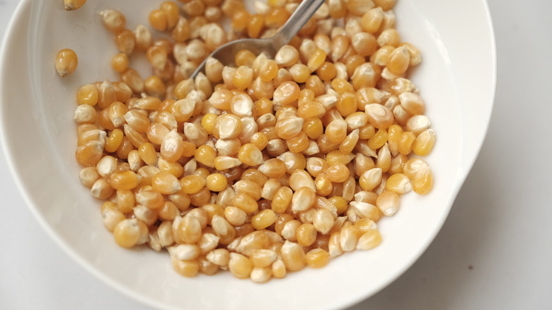 Popcorn kernels coated with oil