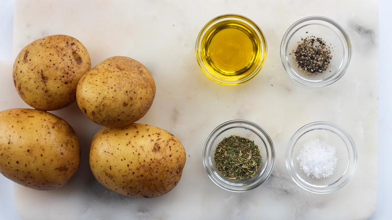 Slices of air fried potatoes in a white bowl with a gold trim