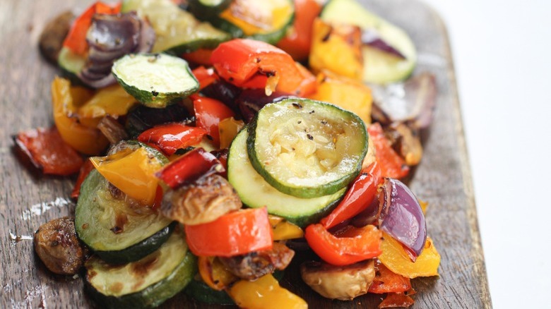 roasted zucchini, mushroom, pepper, and onion on wooden tray